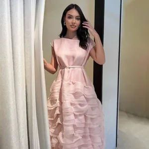 Detailansicht eines eleganten rosa Stufenkleides mit Rüschen und Rundhalsausschnitt
