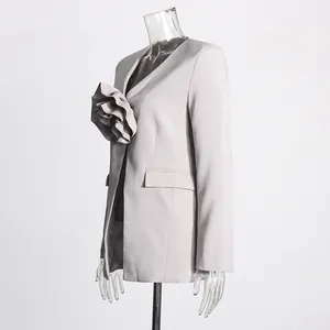 Detailed side view of light grey blazer featuring an oversized 3D fabric flower accent