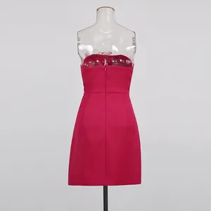 Back view of an elegant fuchsia strapless mini dress with invisible zipper closure.