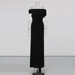 Close-up detail of the elegant black ruched off-shoulder dress with high waist design