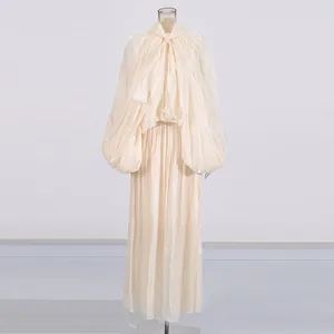 Vue de face de l'élégante robe maxi plissée ivoire avec manches lanternes sur mannequin