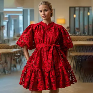 Close-up detail of a vibrant red puff sleeve hollow out lace dress with a stylish waist tie.