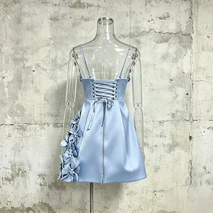 Back detail of blue A-line dress with lace-up corset and 3D floral accents
