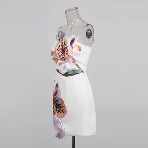 Side view of an elegant white strapless mini dress featuring heavy floral embroidery details