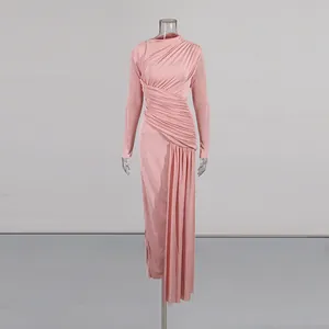 Detail view of pink long sleeve ruched maxi dress with asymmetrical hemline