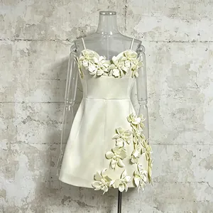 Detailed close-up of a cream A-line camisole dress featuring elegant 3D floral appliqués