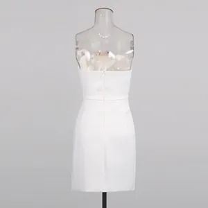 Back view of an elegant white strapless mini dress with invisible zipper closure.
