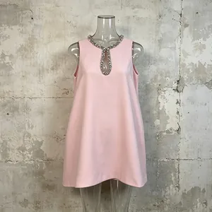 Elegant pink sleeveless dress featuring a sparkling rhinestone collar and keyhole detail