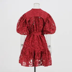 Detailed back view of red puff sleeve dress with hollow jacquard pattern and tie waist