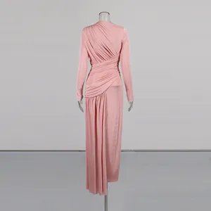 Elegant pink long sleeve ruched maxi dress with drapery details seen from the back