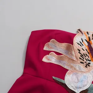 Macro detail shot of heavy floral embroidery on an elegant fuchsia strapless dress