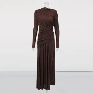 Detailed view of an elegant dark brown long-sleeved pleated maxi dress on mannequin.