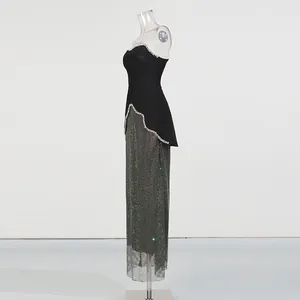 Side view of elegant black strapless top with beads and sequined maxi skirt set