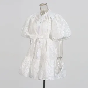 White lace hollow jacquard mini dress featuring dramatic puff sleeves and a waist tie detail