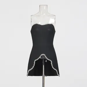Detailed view of a black strapless top with elegant silver beaded trim and scalloped hem