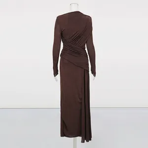 Back view detail of brown ruched long-sleeved maxi dress featuring elegant draping