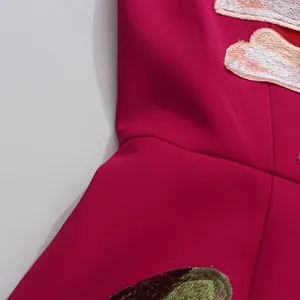 Detail shot of heavy embroidery and fuchsia fabric on an elegant strapless dress.