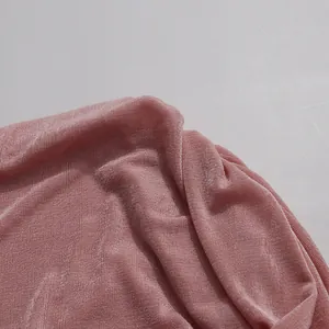 Close-up of pink shimmery pleated fabric showing fine texture and metallic sheen