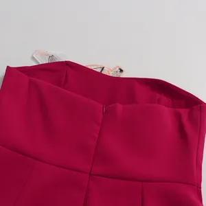 Close-up of the invisible back zipper on a fuchsia strapless dress with embroidery