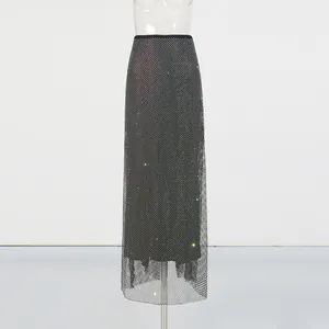 Detail of black high-waisted sequin mesh maxi skirt with sparkling rhinestones.