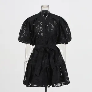Detailed view of a black puff sleeve hollow-out jacquard mini dress with waist belt