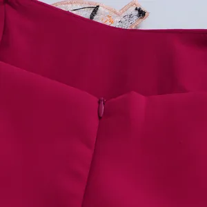 Detail of fuchsia dress featuring a seamless invisible zipper and intricate embroidery