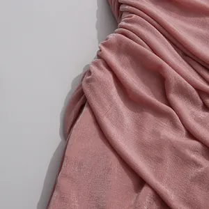 Close-up of pink pleated fabric detail on an elegant summer bodycon beach dress