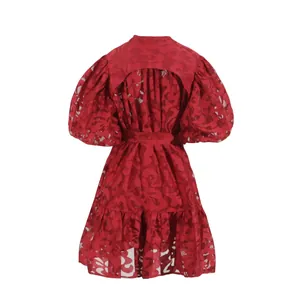 Detail view of red lace puff sleeve dress with hollow back and waist tie.