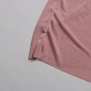 Detailed view of the pink pleated knit fabric and side slit on an elegant long dress