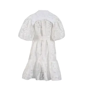 Back view of elegant white jacquard dress featuring puff sleeves and hollow-out detail