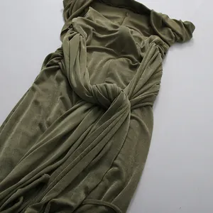Detailed view of the knotted waist and elegant ruching on an olive green midi dress
