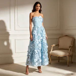 Detailed view of a light blue strapless maxi dress featuring 3D floral embroidery