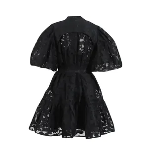 Back view of black lace dress with puff sleeves and hollow floral jacquard detail