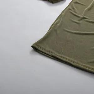 Detailed view of the hem and ribbed fabric of an army green bodycon dress.