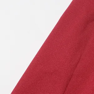 Detailed view of the red ribbed knit fabric texture on a fashionable spring dress