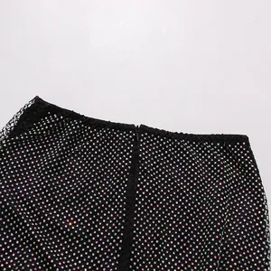 Macro view of iridescent rhinestones on black mesh fabric with a concealed back zipper