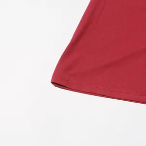 Close-up of the double-stitched hemline and red fabric texture of a women's fashion dress.