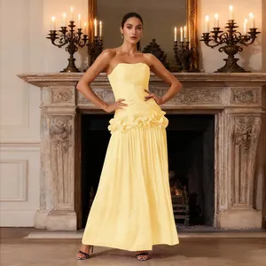 Elegant pale yellow strapless maxi dress featuring pleated bodice and waist ruffles detail.