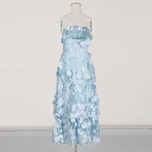 Close-up of light blue strapless long dress with 3D floral embroidery detailing