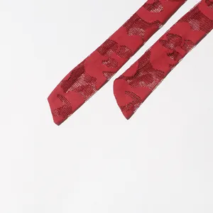 Macro view of red hollow-out jacquard mesh fabric tie straps for a modern dress detail