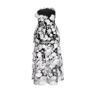 Detail view of elegant strapless tiered maxi dress with 3D floral embroidery details.