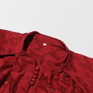 Detailed close-up view of a red hollow jacquard lace dress collar and fabric texture