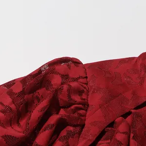 Detailed close-up of red hollow-out floral lace fabric on a stylish puff sleeve dress