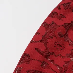 Detailed macro shot of red hollow jacquard floral lace fabric texture for women's dress