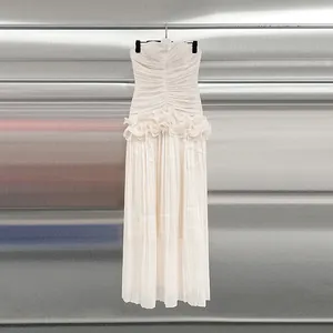 Elegant off-the-shoulder cream maxi dress with ruffled waist and pleated details.