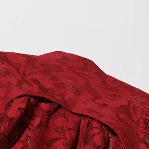 Detailed macro view of red hollow-out jacquard lace fabric on a spring fashion dress