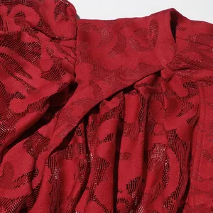 Macro view of red hollow jacquard lace fabric detail on fashionable dress