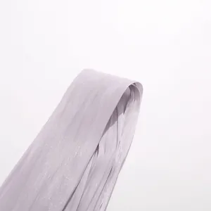 Close-up view showing the shimmering lavender pleated fabric and texture of this halter dress.