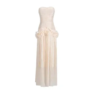 Elegant champagne strapless maxi dress featuring ruffled waist and pleated fabric
