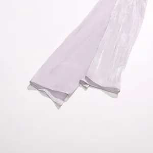 Close-up detail of shimmering lavender pleated fabric sash on a party dress